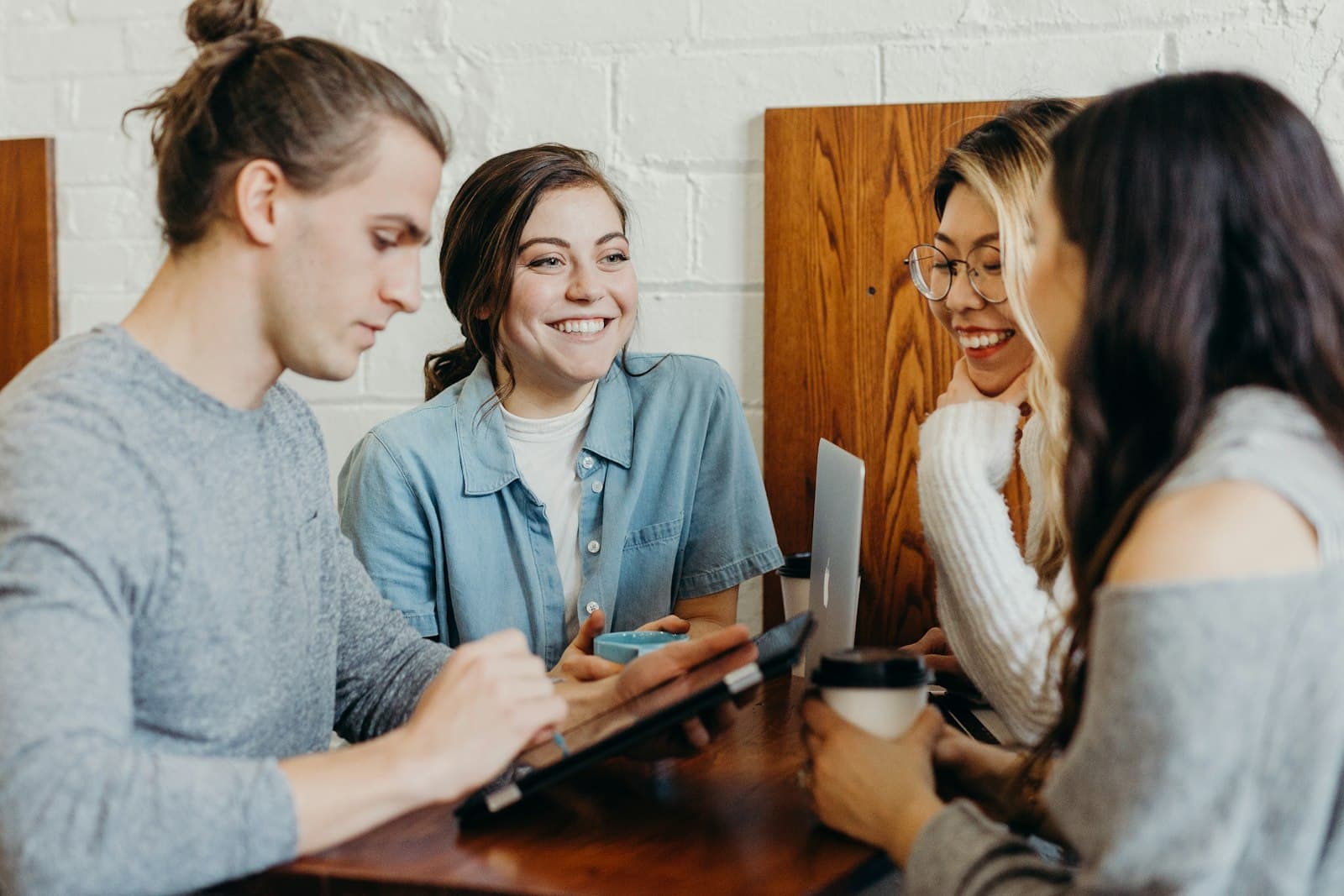 Small group in warm conversation around a table